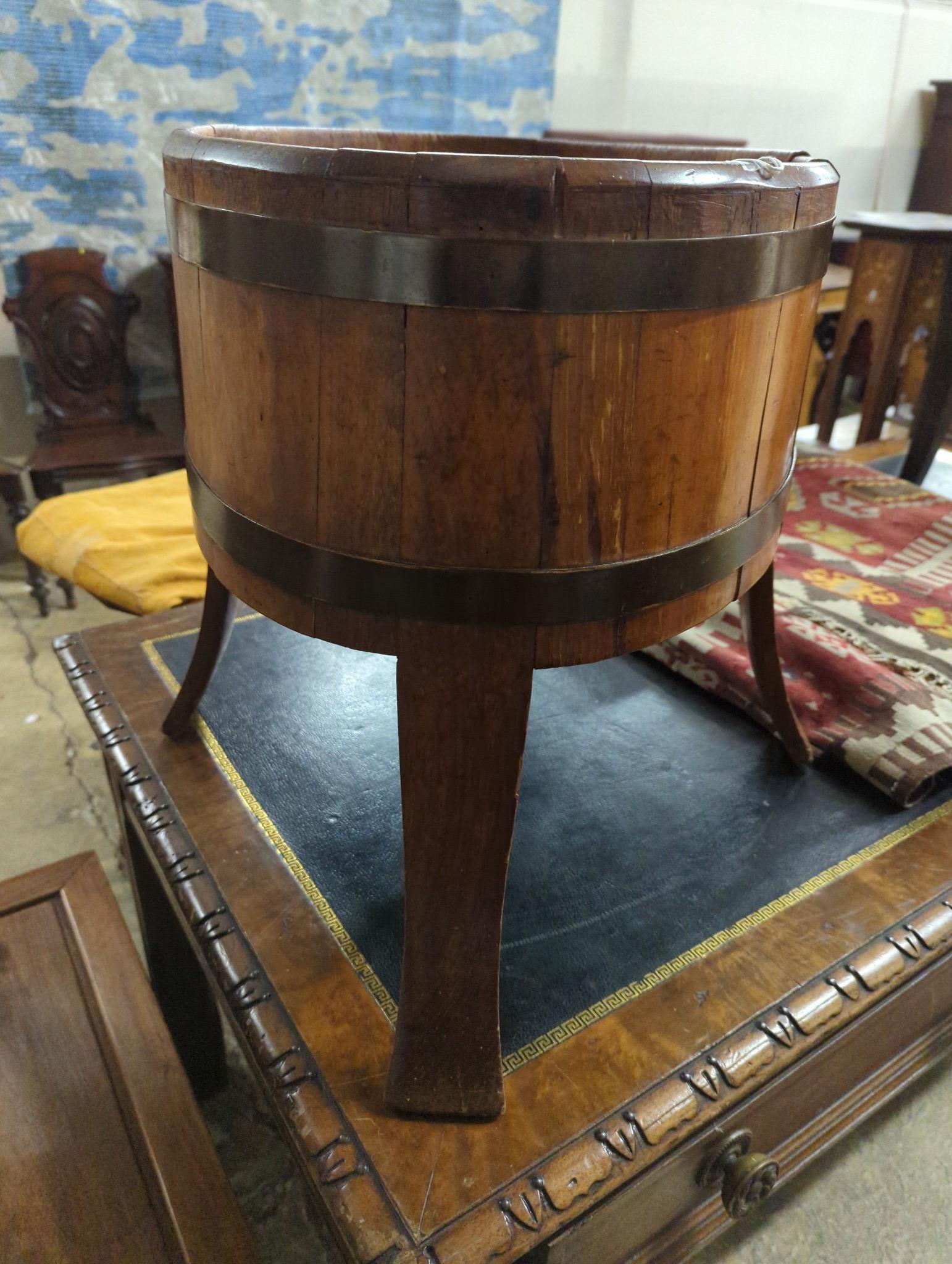 A George III style brass bound coopered mahogany oval planter / wine cooler, width 62cm, depth 41cm, height 49cm